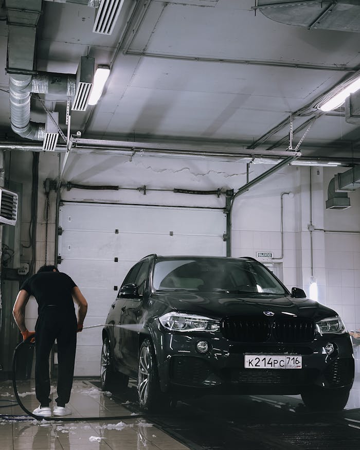 Professional car washing in a garage setting with a focus on car care.